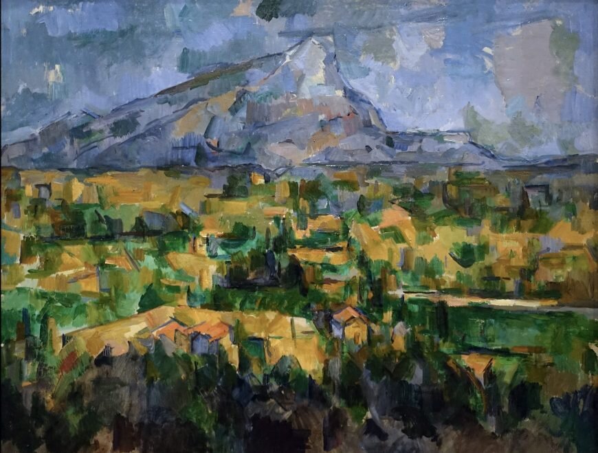 Painting of a blue-grey mountain above a plain built from patches of ochre and green